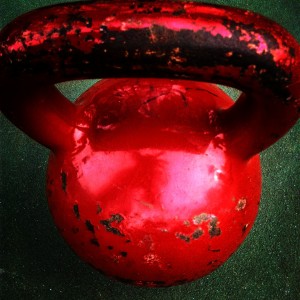 A big red kettlebell with scuff marks. 