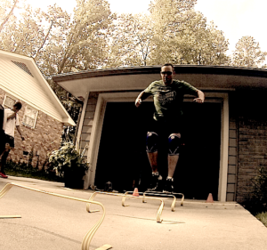 Brandon Richey Fitness student bounding hurdles for plyometric training 