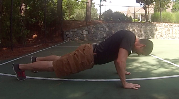 Brandon demonstrating improper shoulder blade stability in the upright push-up position allowing his head fall out of alignment towards the ground. 