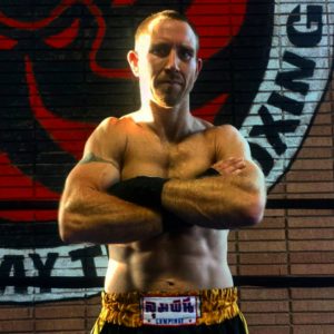 U.S. National Champion Muay Thai fighter Jeff Perry standing with arms crossed