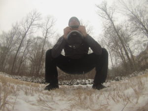 Brandon performing a kettlebell goblet squat in the snow. 