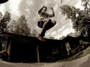 A ground up view of a man performing hurdle bounds. 