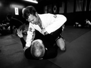 Black and white image of two men grappling in BJJ. 